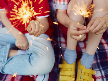 a boy and a girl holding sparklers